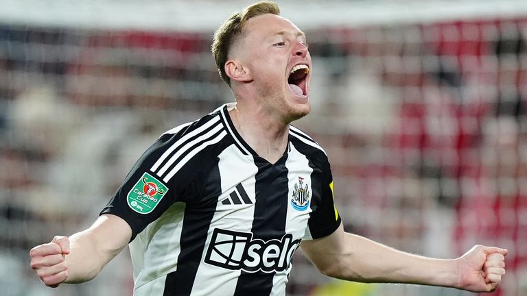 Sean Longstaff celebrates after scoring Newcastle's winning penalty. 